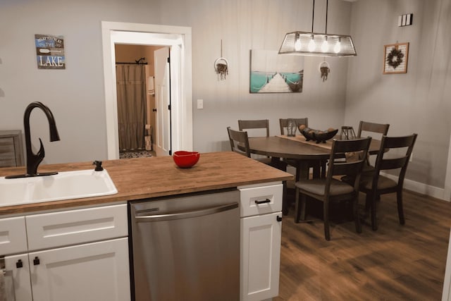 kitchen with dark wood-type flooring, sink, white cabinetry, decorative light fixtures, and dishwasher