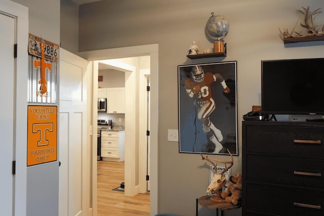 corridor with light hardwood / wood-style floors