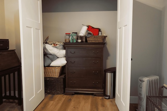 interior space featuring radiator heating unit and light hardwood / wood-style floors