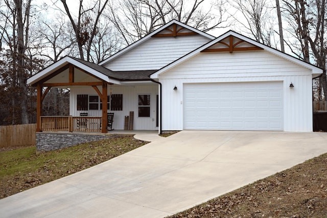 view of front of house featuring a porch and a garage