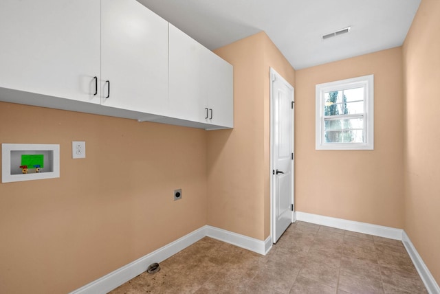 laundry area with electric dryer hookup, hookup for a washing machine, and cabinets