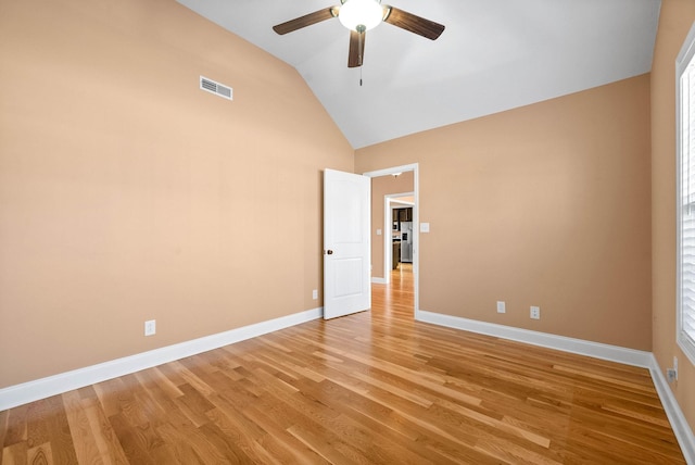 unfurnished bedroom featuring lofted ceiling, light hardwood / wood-style floors, and ceiling fan