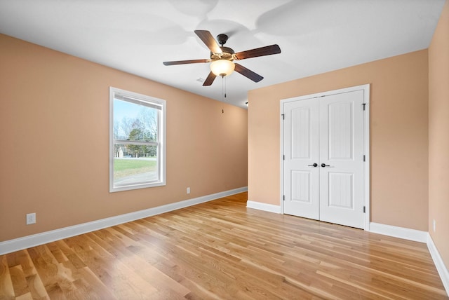 unfurnished bedroom featuring a closet, ceiling fan, and light wood-type flooring