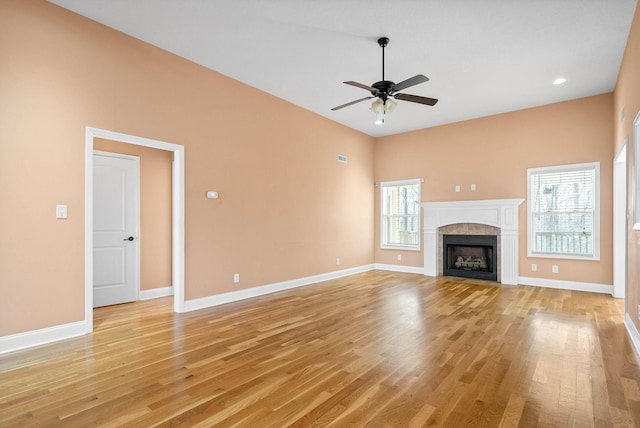 unfurnished living room with ceiling fan and light hardwood / wood-style flooring