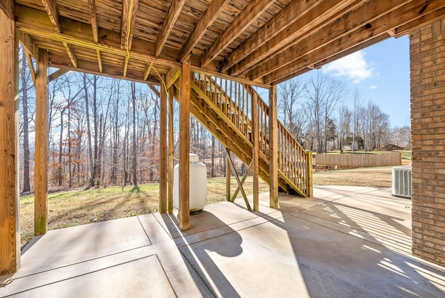 view of patio featuring a storage shed and central AC