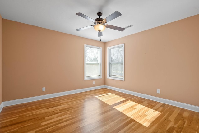 empty room with light hardwood / wood-style flooring and ceiling fan