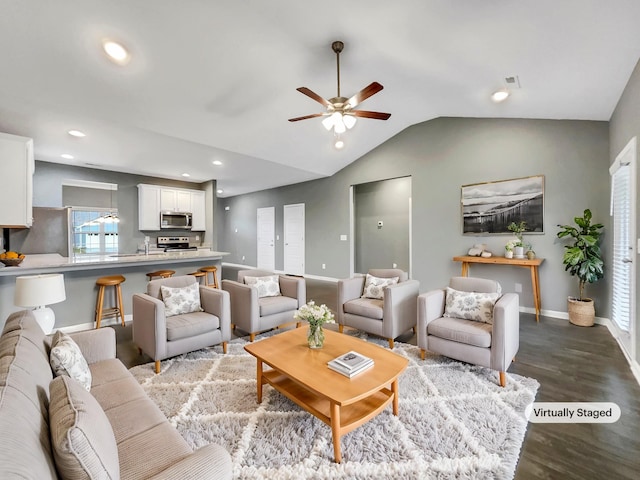 living room featuring ceiling fan, lofted ceiling, and light wood-type flooring