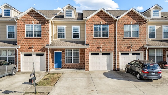 view of property featuring an attached garage, driveway, brick siding, and a shingled roof