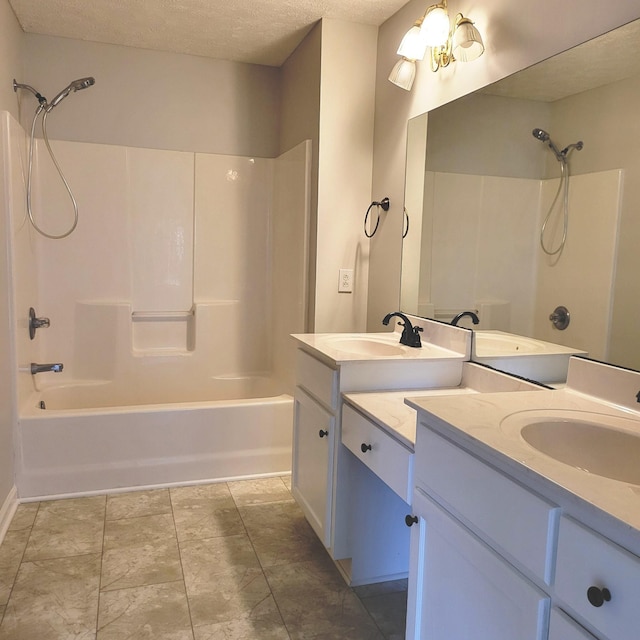 bathroom with vanity, shower / bath combination, and a textured ceiling