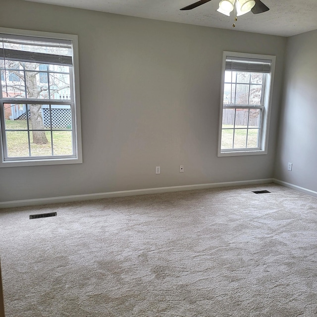 unfurnished room featuring ceiling fan, carpet floors, and a textured ceiling