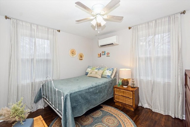 bedroom with dark wood-type flooring, ceiling fan, and a wall mounted air conditioner