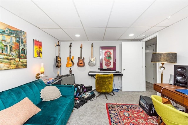 living room with carpet and a paneled ceiling