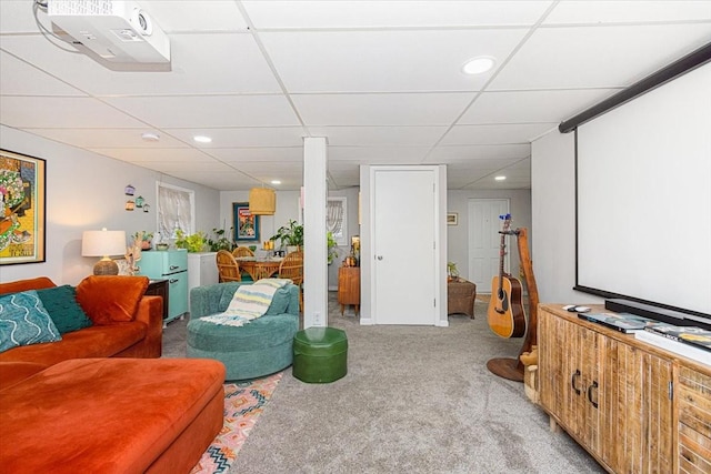 carpeted cinema with a drop ceiling