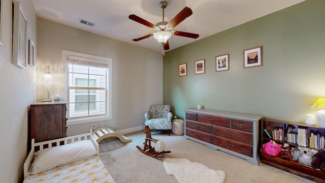 sitting room featuring ceiling fan and light carpet