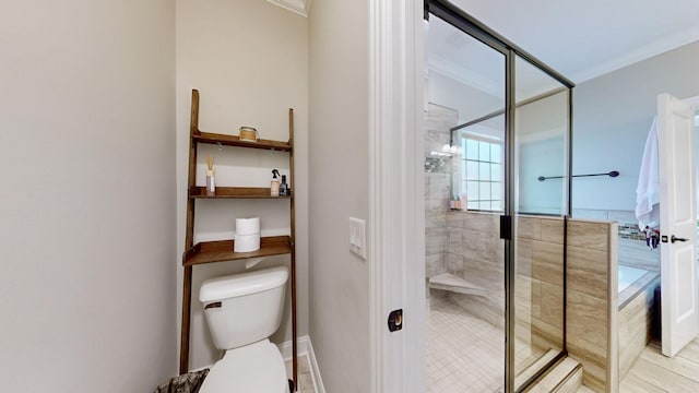 bathroom featuring crown molding, toilet, and walk in shower