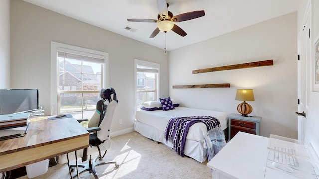 bedroom with ceiling fan and light carpet