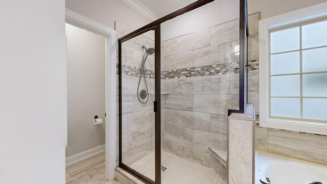 bathroom with ornamental molding, independent shower and bath, and a wealth of natural light