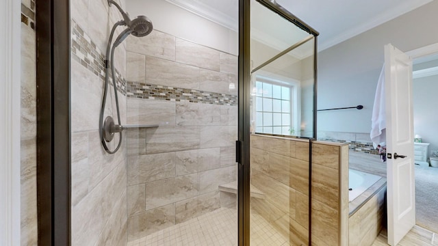 bathroom with ornamental molding and separate shower and tub