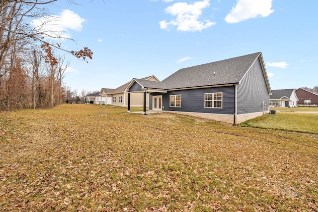 rear view of house with a yard