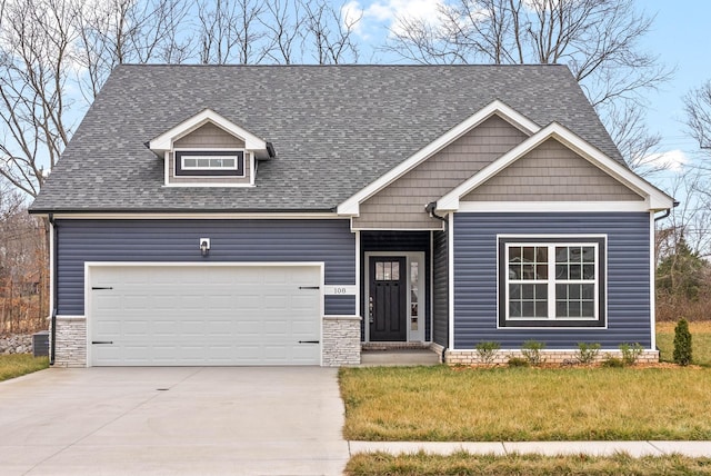 craftsman-style home with a garage and a front lawn