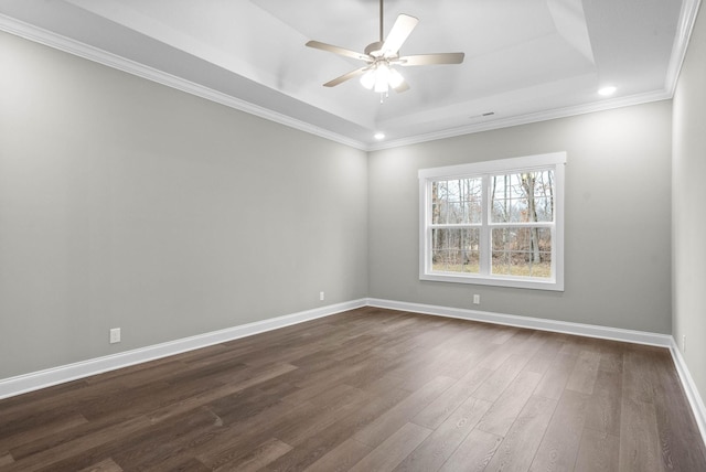 unfurnished room featuring ceiling fan, ornamental molding, a tray ceiling, and dark hardwood / wood-style flooring