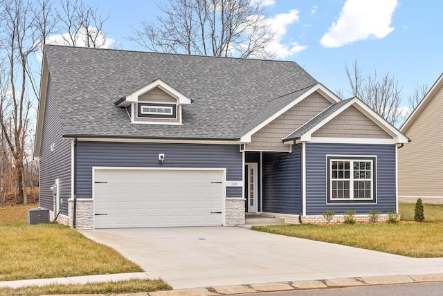 craftsman-style home with a garage, central AC, and a front lawn