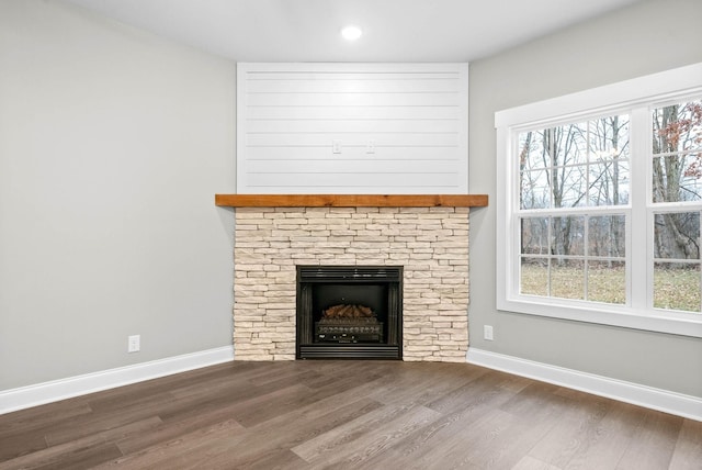 unfurnished living room with a fireplace and dark hardwood / wood-style floors