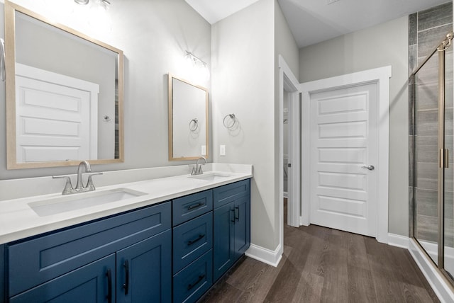 bathroom with vanity, hardwood / wood-style floors, and a shower with shower door