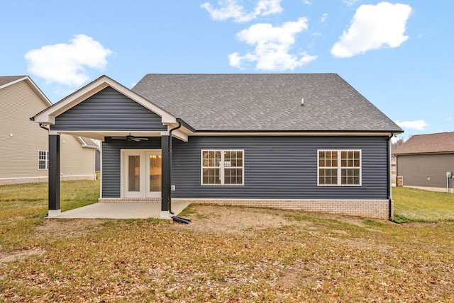 back of property with a lawn, a patio, and ceiling fan