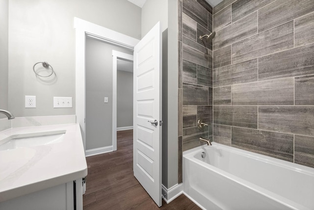 bathroom featuring vanity, hardwood / wood-style flooring, and tiled shower / bath