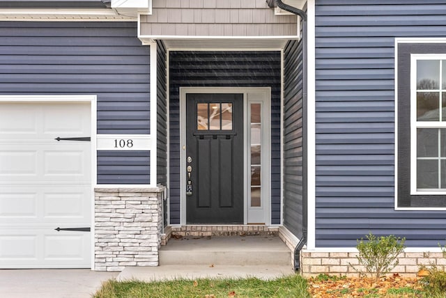 doorway to property featuring a garage