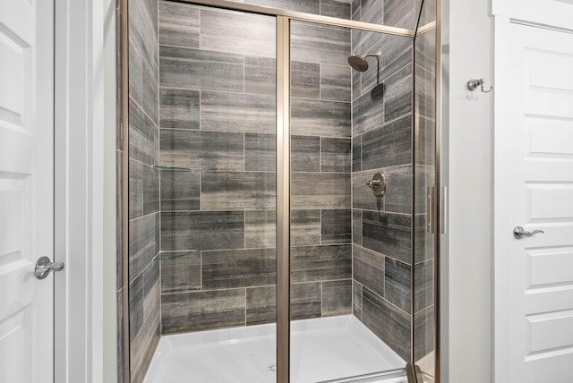 bathroom featuring a shower with shower door