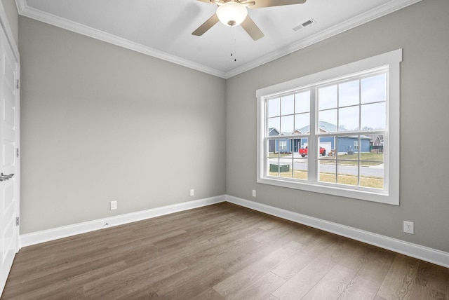 empty room featuring ornamental molding, hardwood / wood-style floors, and ceiling fan