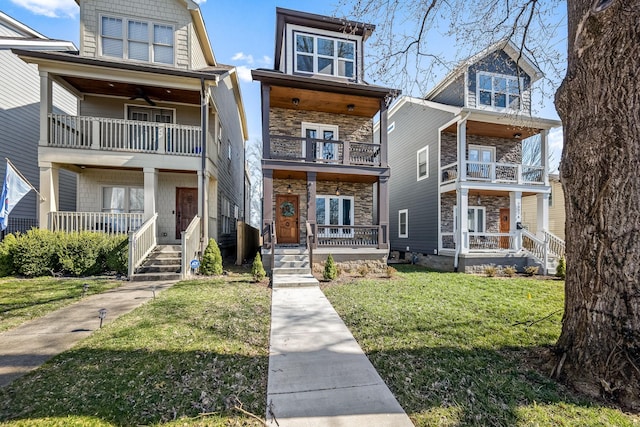 view of front of property featuring a balcony and a front lawn