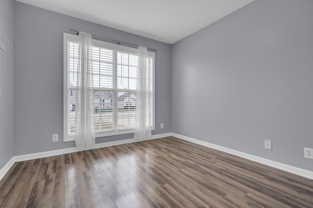 unfurnished room featuring dark hardwood / wood-style flooring