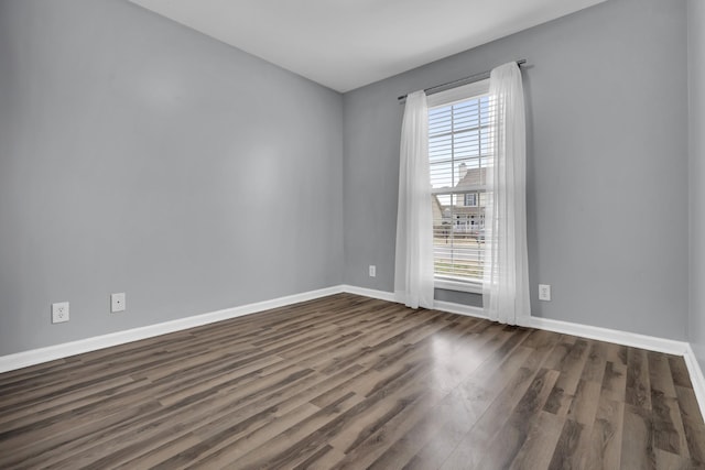 spare room with dark wood-type flooring