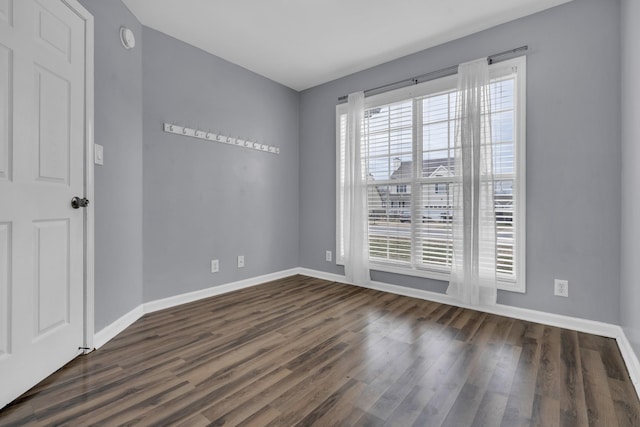 unfurnished room with dark hardwood / wood-style floors