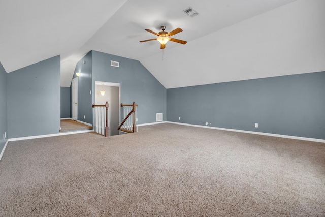 additional living space with vaulted ceiling, carpet flooring, and ceiling fan