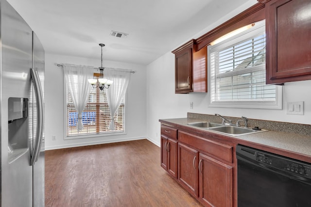 kitchen featuring dishwasher, pendant lighting, stainless steel fridge, sink, and dark hardwood / wood-style floors