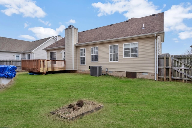 back of property with a deck, central air condition unit, and a lawn