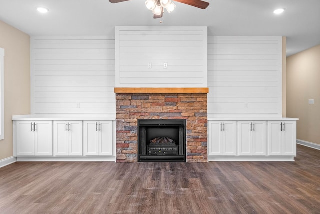 unfurnished living room featuring ceiling fan, a fireplace, and dark hardwood / wood-style flooring