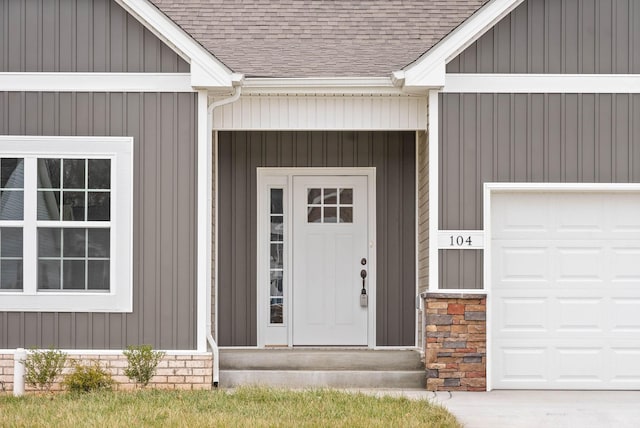 doorway to property with a garage