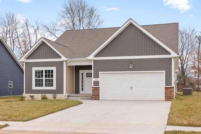 craftsman-style home with a garage, central AC unit, and a front lawn