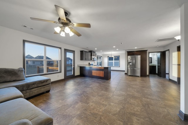 unfurnished living room with ceiling fan