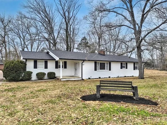 ranch-style house featuring a front lawn, a chimney, and a shingled roof