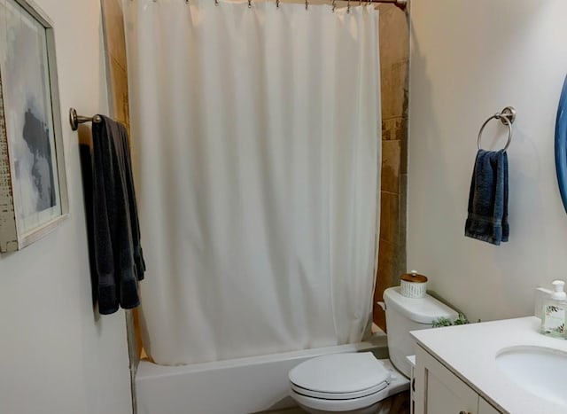 full bathroom featuring shower / bath combo with shower curtain, vanity, and toilet