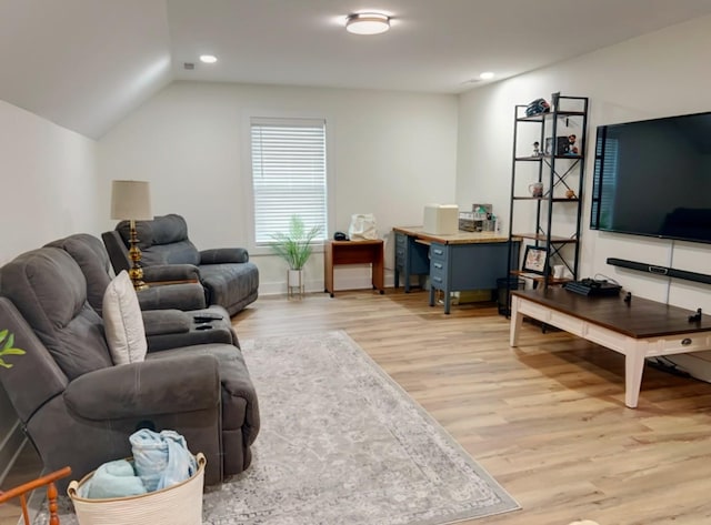 living room featuring light hardwood / wood-style flooring and vaulted ceiling