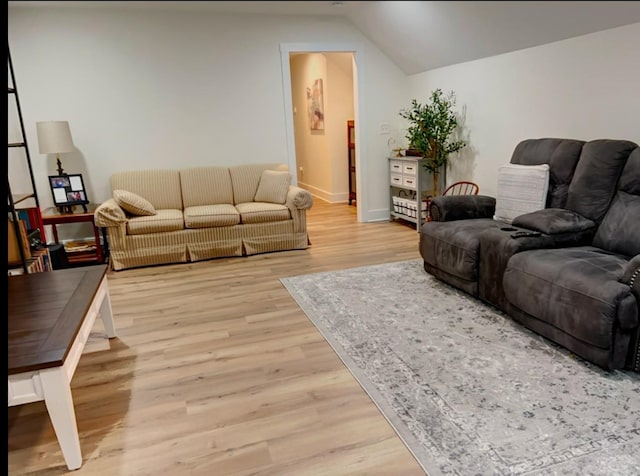 living room featuring light hardwood / wood-style floors and lofted ceiling