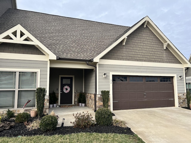 craftsman inspired home with a porch and a garage