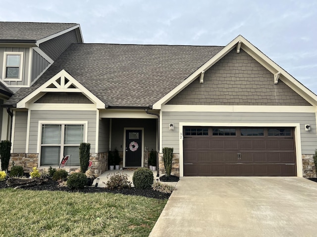 craftsman-style house featuring a front lawn and a garage